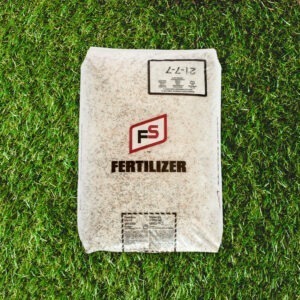 A sealed bag of FS fertilizer rests on vibrant green grass, displaying product details, brand logo, and nutrient composition.