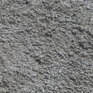 This image shows a close-up view of a rough, textured gray surface, possibly concrete. No recognizable landmarks or buildings are visible.