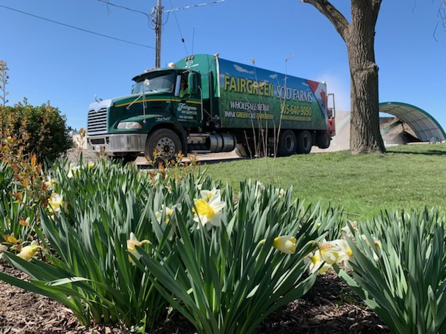 A Fairgreen truck helping a client put summer lawn care tips into action.