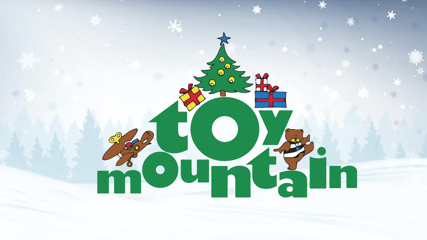 Festive "Toy Mountain" logo features a Christmas tree, gifts, bear, and airplane against a snowy forest backdrop with falling snowflakes.